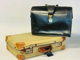 two suitcases sitting next to each other on a white surface