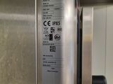 a stainless steel refrigerator with a sticker on the door
