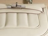 a white purse sitting on top of a wooden table