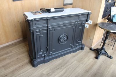 a black cabinet with a marble top in a room