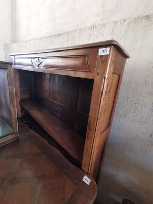 a wooden cabinet that has a glass door on top of it