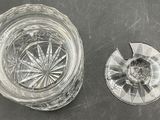 a glass of water and a broken glass on a table