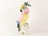 a figurine of a parrot sitting on top of a white elephant