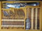 many forks and spoons in a wooden box