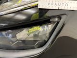 a close up of a car ' s headlight with a sticker on it