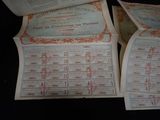 several old papers are stacked on top of each other on a table