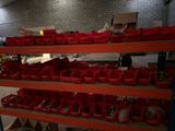 many red bins on the shelves in the garage