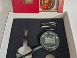 a box with a bottle and spoon in it