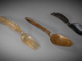 three different types of spoons and a fork on a table