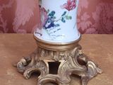 a vase that is sitting on a table with flowers on it