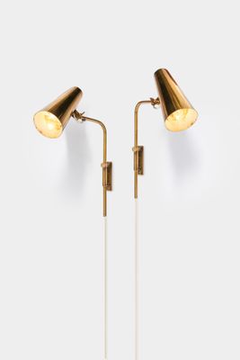 a pair of brass lamps on a white background