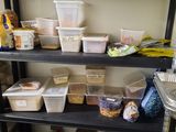 a black shelf with plastic containers and containers on it