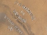 a close up of a silver plate with writing on it