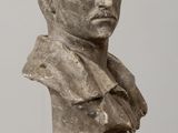an image of a bust of a man sitting on top of a wooden table