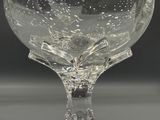 a clear glass goblet sitting on top of a table