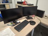two computer monitors and a keyboard on a desk