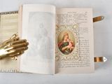 an open book with a picture of a woman holding a baby