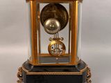 a black and gold clock sitting on top of a table