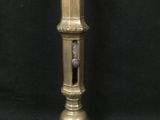 brass plated candle holder on a black background with a black background
