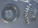 a lot of silver spoons and silverware on the table