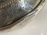a silver plate with a silver lid sitting on a table
