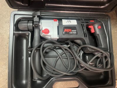 a black box with a cord and a drill in it