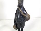 statue of a rabbit with a hat and a bag on a base