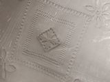 a close up of a white plate with a decorative design
