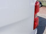a white van that is parked on the side of the road
