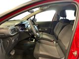 the interior of a red car with a steering wheel and a dashboard