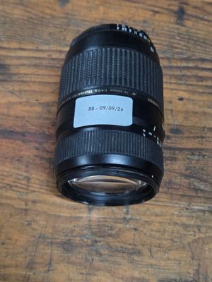 a close up of a camera lens sitting on a wooden table