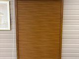 a wooden door that is open on the side of a building
