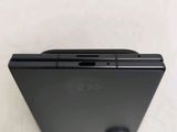 a close up of the back of a cell phone on a white surface