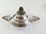 a silver plate with a bird on it
