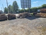 a pile of wood sitting on the ground in front of a basketball court