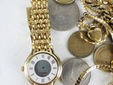 a lot of coins and a watch on a table