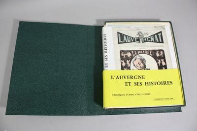 the book is open on a table with a green cover