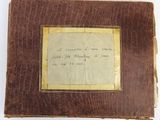 an old book with writing on it sitting on top of a table