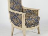 an upholstered chair with a blue and gold patterned upholstered seat