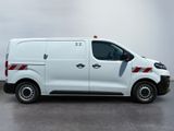 a white van with red stripes parked in a parking lot