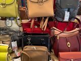 a lot of purses on a table in a store