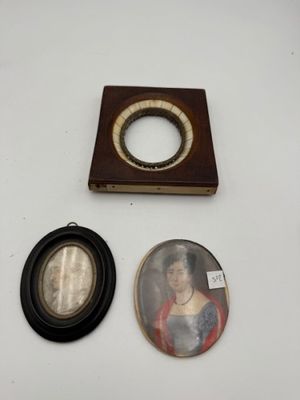 three framed pictures and a picture of a woman are on a table