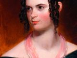 portrait of a woman in a black dress with a pink scarf