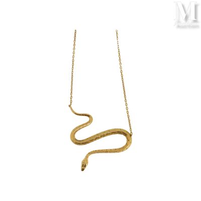 a gold snake necklace with a chain on a white background