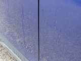 a close up of a blue car with a broken door handle