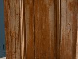 an old wooden door that is open on the floor