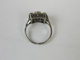 a close up of a ring on a table with a white background