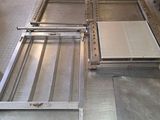 a large metal table in the middle of a kitchen