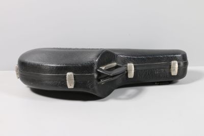 a guitar case sitting on a table with a white background