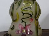 a glass vase with flowers on it sitting on a table